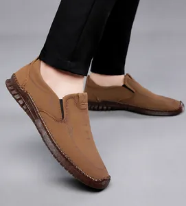 Detailed close-up of brown casual men's loafers with non-slip rubber soles and sport logo
