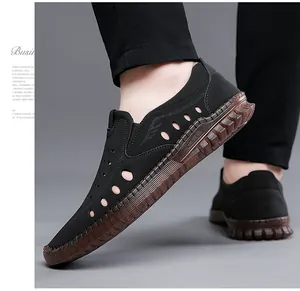 Close-up of men's black hollow-out casual shoes with breathable perforated leather design