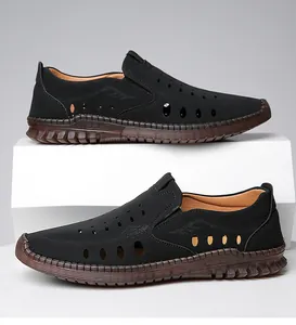 Detail view of men's hollow leather sandals with brown thick non-slip soles and round holes