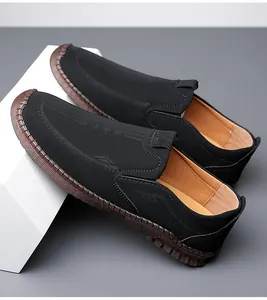 Detail view of black leather loafers with kangaroo embossing and hand-stitched rubber soles