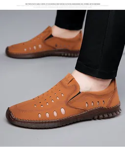 Macro shot of brown leather men's sandals with laser-cut holes and sport label