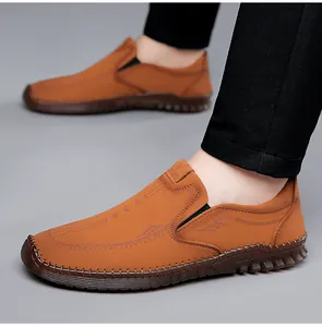 Detailed view of hand-stitched brown leather loafers with non-slip rubber soles