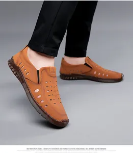 Detail of brown leather sandals with circular perforations and hand-stitched seams