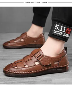 Close-up of brown leather men's sandals with breathable woven design and velcro strap