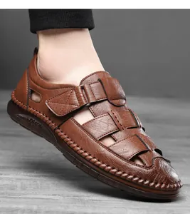 Close-up of brown leather closed-toe sandals with breathable hollow weave and velcro strap