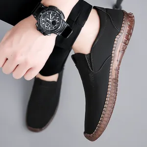 Men's casual black slip-on loafers with durable brown rubber sole and stitched detailing