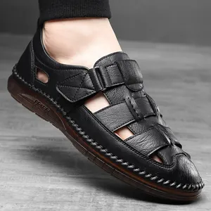 Men's black leather sandals with hollow cutouts and velcro strap on rubber sole