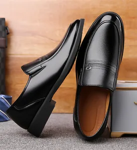 Close-up of black leather business shoes with polished toe and side metal buckle detail