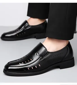 Detail of men's black leather loafers featuring breathable laser-cut perforations on feet