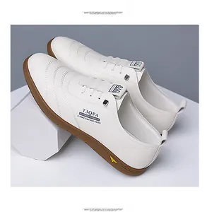 Detail of white leather men's sneakers with wavy stitching and brown rubber sole