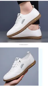 Close-up of white casual sneakers showing leather texture and brown gum sole detail