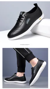 Detail of black leather casual shoe with rubber sole and yellow lightning bolt accent