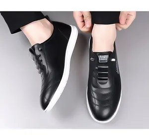 Detail view of black casual leather shoes featuring decorative stitching and white flat sole