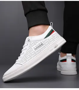 Detail view of white leather sneakers featuring breathable hollow holes and webbing