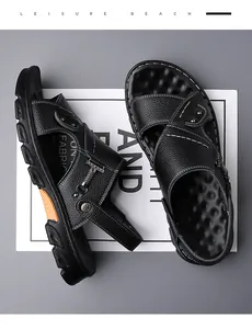 Detail of black leather men's sandals with white stitching and orange sole accents