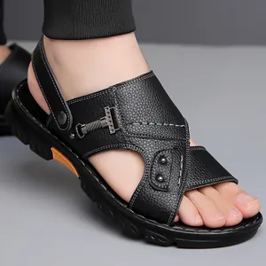 Men's black leather sandals with cross straps and orange sole accents shown on feet