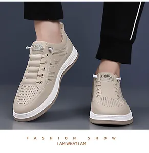 Detailed close-up of beige casual men's sneakers with laser-cut breathable perforations