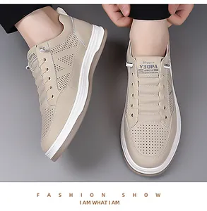 Close-up of beige breathable hollowed leather casual men's shoes with thick white soles
