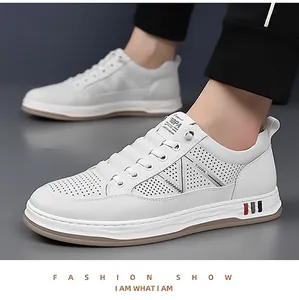Detail of white leather men's sneakers with breathable perforations and V-shaped design