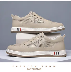 Detail of breathable perforated mesh upper on beige men's casual sneaker with fashion stripes