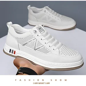 Detail of white men's breathable casual sneakers with perforated leather and thick soles