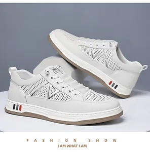 Detail of perforated white leather upper with V-shaped stitching and textured sole accents