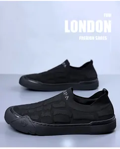 Detail of black men's slip-on sneaker with textured knit fabric and anti-slip rubber sole