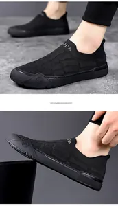 Detail of black breathable knit texture and white letter branding on men's slip-on sneaker