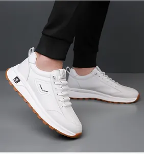 Detail view of white fashion sports sneakers featuring non-slip brown rubber soles