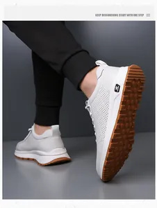 Close-up of men's white leather sneaker featuring perforated side and anti-slip rubber sole