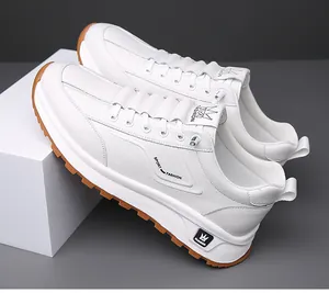 Detail view of white men's sneakers with anti-slip rubber sole and crown design