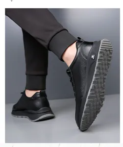 Detail of men's casual black leather shoes with perforated texture and rubber sole