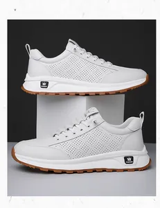 Detail of white hollowed-out casual sneakers featuring brown anti-slip rubber soles