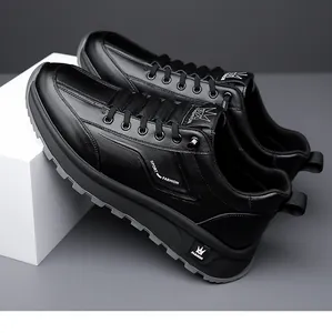 Detail view of black leather sneaker featuring embossed logo and anti-slip rubber sole