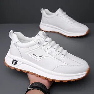 White faux leather men's sneakers with non-slip brown rubber soles and sport laces