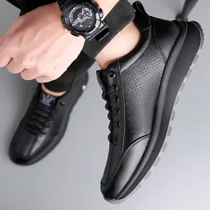 Men's casual black slip-on sneakers with breathable perforated leather and thick gray soles
