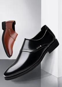 Detail of black and brown slip-on leather shoes with metal buckles and perforated accents