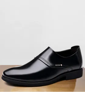 Detailed close-up of men's black business dress shoes with textured side patterns