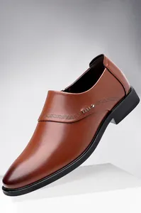 Close-up of brown leather business shoes showing stitching and metallic detail
