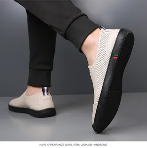 Detail of perforated leather loafers with red-green stripe on thick rubber soles