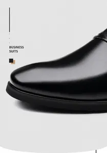 Detail shot of glossy black leather upper with fine texture for business dress shoes