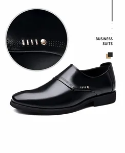 Detail view of black slip-on business shoes with metal rivets and decorative stitching