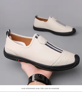 Close-up of beige leather slip-on loafers with breathable perforations and thick black soles