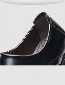Detail view of the breathable dark brown inner lining of black leather business formal shoes