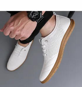 Details von weißen Lederherrenschuhen mit atmungsaktiver Perforation und Gummisohle