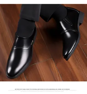 Top-down view of men's black leather business shoes with elegant perforated details