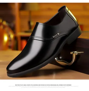 Detail of black leather business shoes with fine perforated patterns and metallic accents