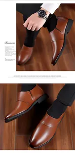 Close-up of brown leather business loafers with elastic side and polished finish