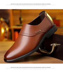 Detail of brown leather business shoe with metal buckle and brogue perforations