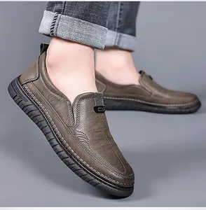 Detail view of brown slip-on loafers with durable rubber sole and CS logo detail